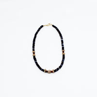 Stunning black puka mixed with gold plated spacers, gold platted spacers with cz detail, and brown beads. 16-18 inches in length. Handmade Jewelry. Stunning blue and gold necklace. Women Necklace. Girl Necklace. Gold Jewelry. Black Jewelry. Gold Jewelry. Brown Jewelry. Black Puka. Miami. Miami Jewelry. Affordable Sustainable Jewelry. Affordable Prices. Jewellery. Jewelry stores. Customized Jewelry. MCHARMS. Shop Jewelry. 