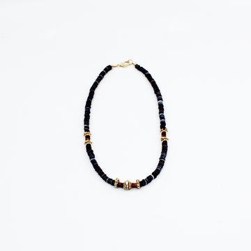 Stunning black puka mixed with gold plated spacers, gold platted spacers with cz detail, and brown beads. 16-18 inches in length. Handmade Jewelry. Stunning blue and gold necklace. Women Necklace. Girl Necklace. Gold Jewelry. Black Jewelry. Gold Jewelry. Brown Jewelry. Black Puka. Miami. Miami Jewelry. Affordable Sustainable Jewelry. Affordable Prices. Jewellery. Jewelry stores. Customized Jewelry. MCHARMS. Shop Jewelry. 